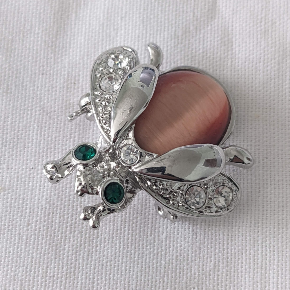 Beatle Brooch, Silver body with green eyes and a bronze color back.